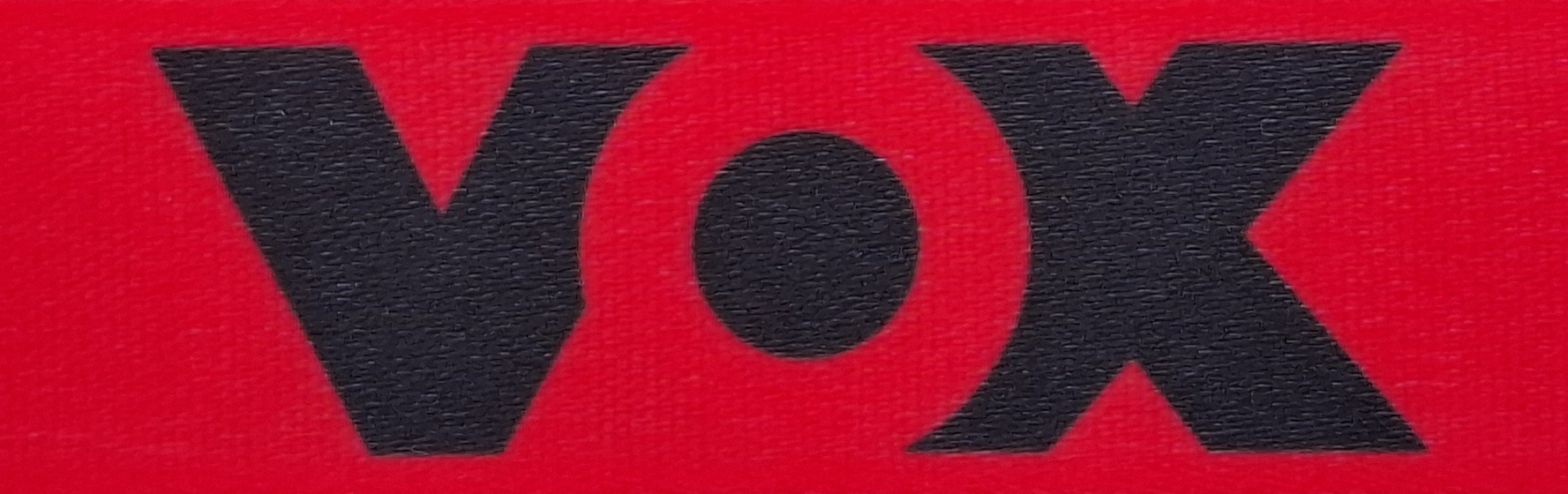Logo with the lettering "VOX" in black on a red background.